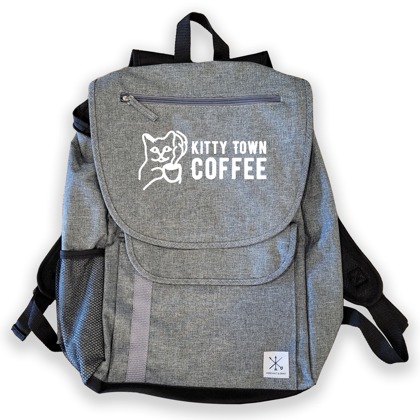 A gray Kitty Town laptop backpack with a logo on the front, featuring multiple compartments and side mesh pockets.