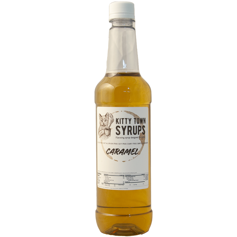 A plastic bottle of Kitty Town Syrups with the label Caramel Flavoring Syrup visible.