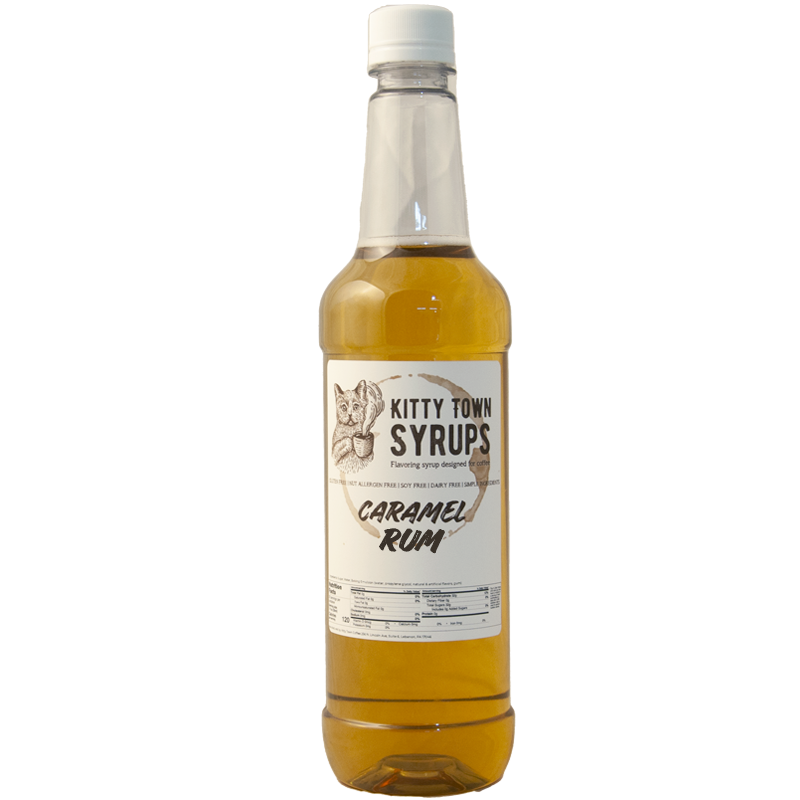 A plastic bottle of Caramel Rum flavoring syrup with a white label and gold cap.