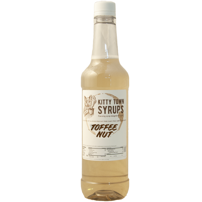 A plastic bottle of Kitty Town Syrups with the label Toffee Nut Flavoring Syrup visible.