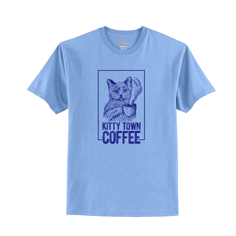 A light blue t-shirt with 'Kitty Town Coffee' text and a graphic of a cat in a square frame on the front.