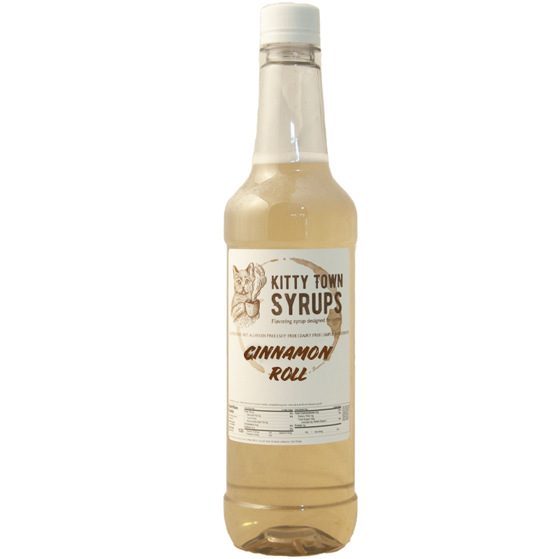 A plastic bottle of Kitty Town Syrups with the label Cinnamon Roll Flavoring Syrup visible.