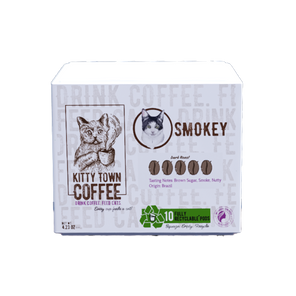 A box of Kitty Town Coffee Smokey single use pods with a graphic of a cat, compatibility note for Keurig K-Cup, and recycling symbol indicating recyclable packaging.