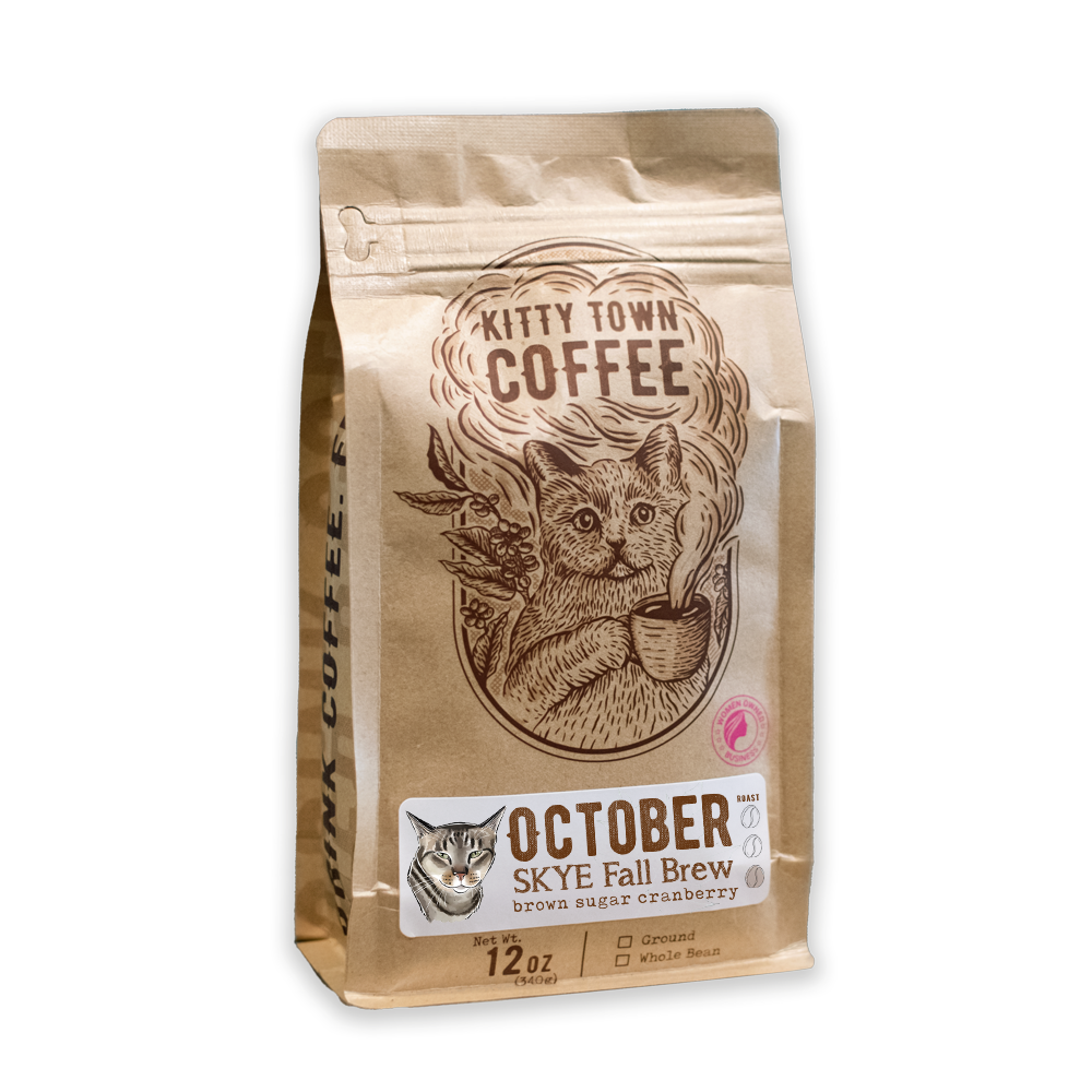A bag of Kitty Town Coffee's October Skye Fall Brew, with an illustration of a cat and a mug