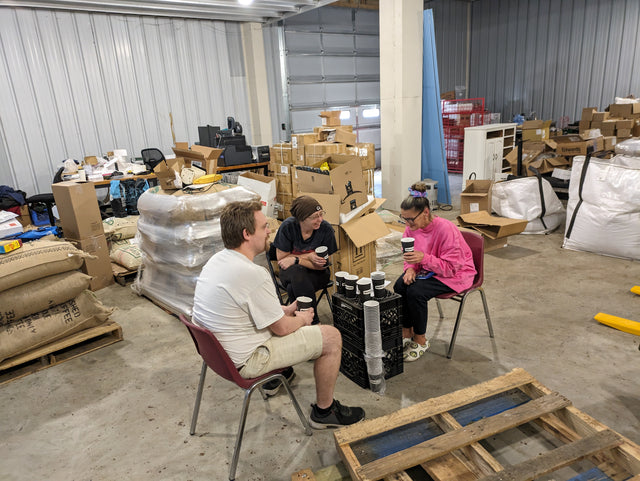 The Kitty Town roastery team sampling coffee together in the warehouse