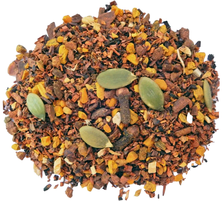 A close-up of dried pumpkin chai herbal tea ingredients, featuring a mix of brown and yellow spices with visible herbs and spice particles.