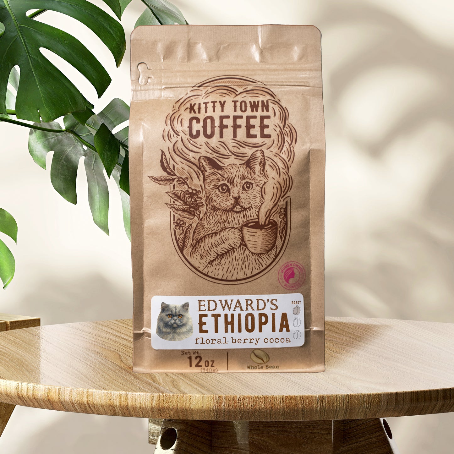 Kitty Town Coffee bag with a cat illustration on a wooden surface