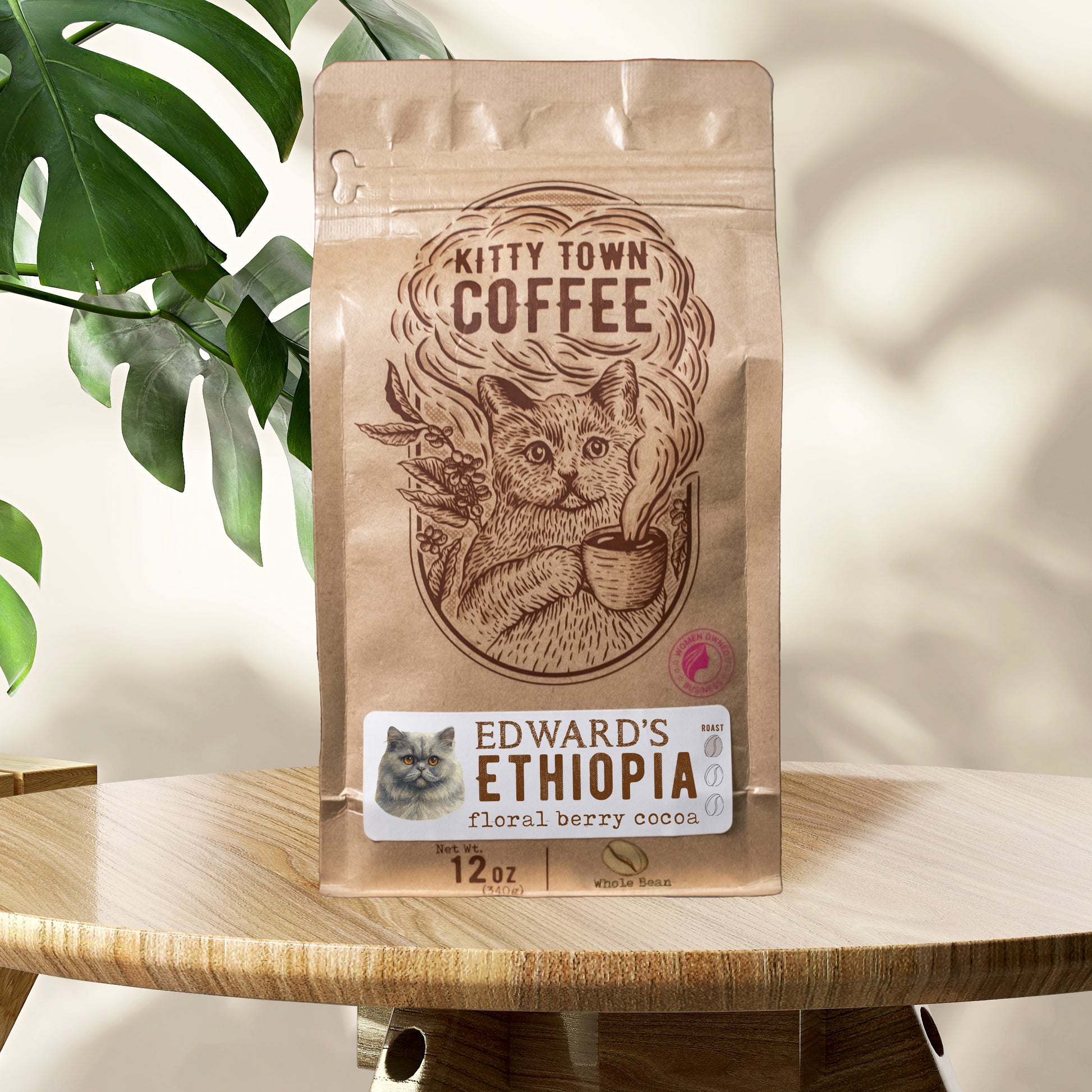 Kitty Town Coffee bag with a cat illustration on a wooden surface