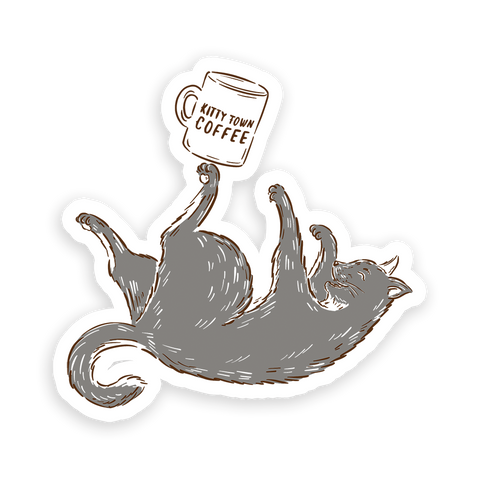A sticker design featuring a cat lying down with a mug in its paw, and the text 'Kitty Town Coffee'.